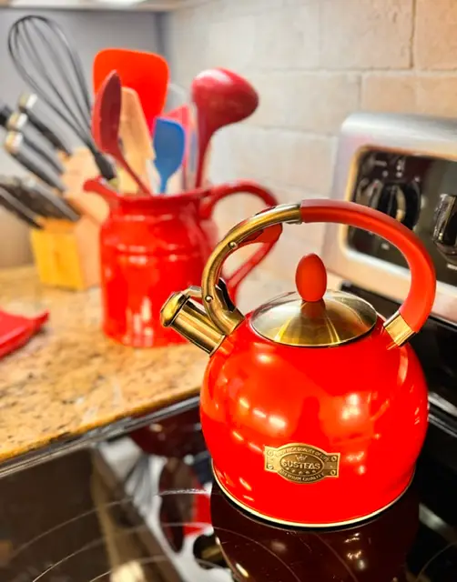 Cherry-red tea kettle and utensil crock in the kitchen